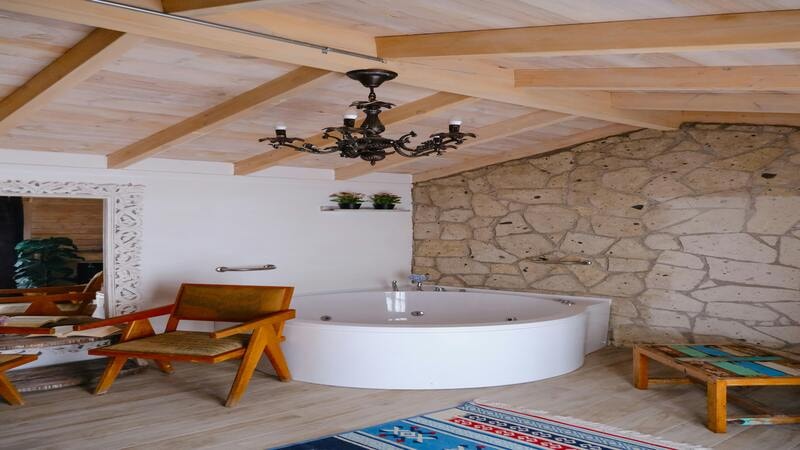 Metallic fixture chandelier in a wooden cottage