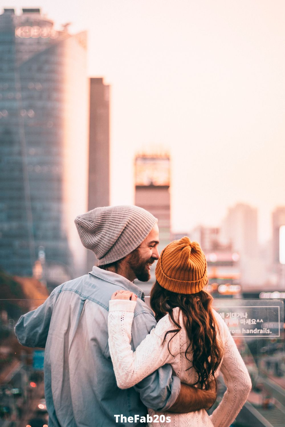 Couple hugging in a big city - Body language of a man secretly in love with you