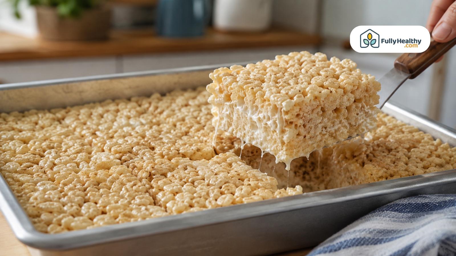 Fresh rice crispy treat lifted from baking pan showing gooey marshmallow texture