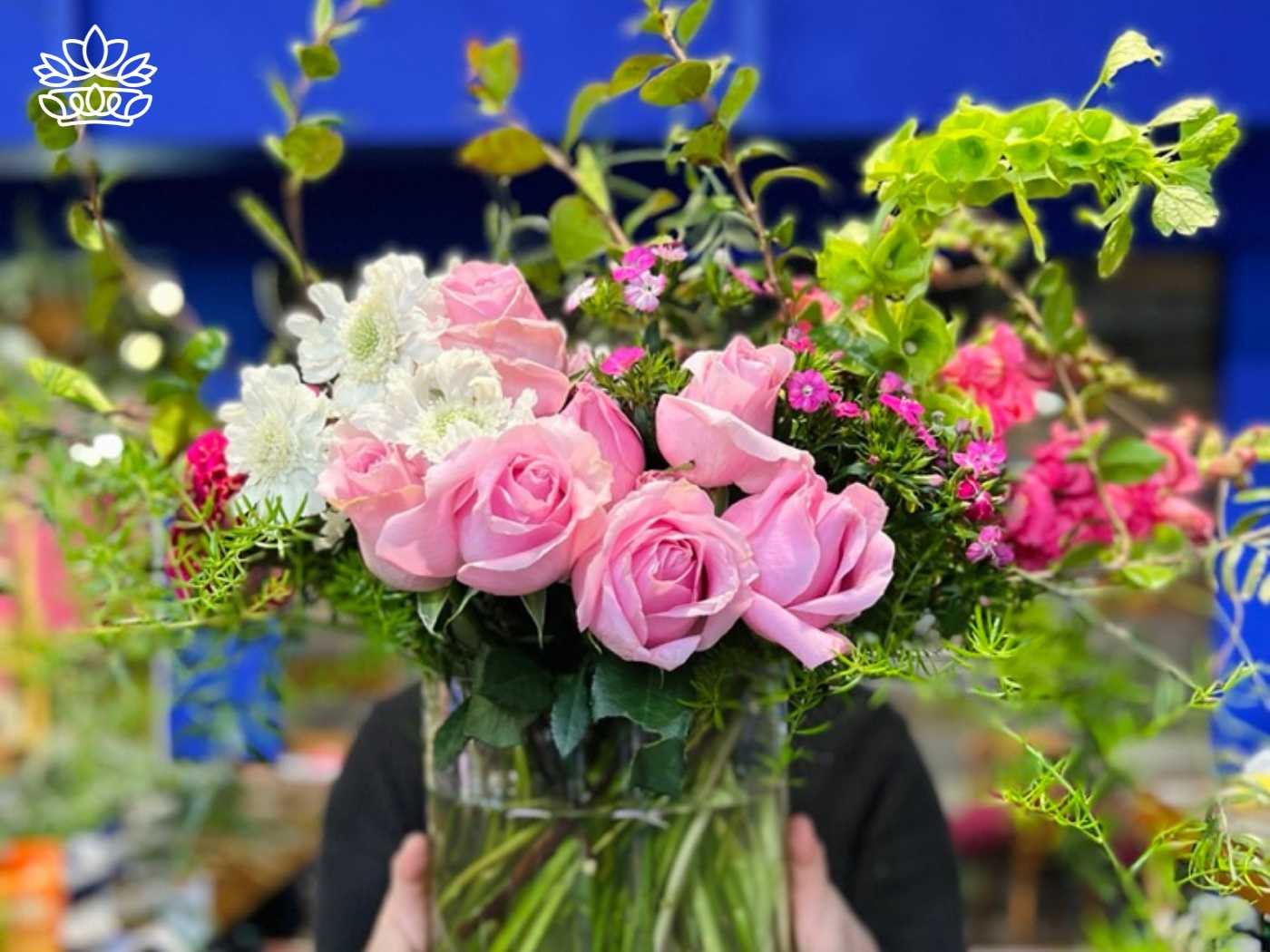 A bouquet of soft pink roses and vibrant greenery, ready for efficient delivery, perfect for birthdays or browsing in the business shop at Fabulous Flowers and Gifts.