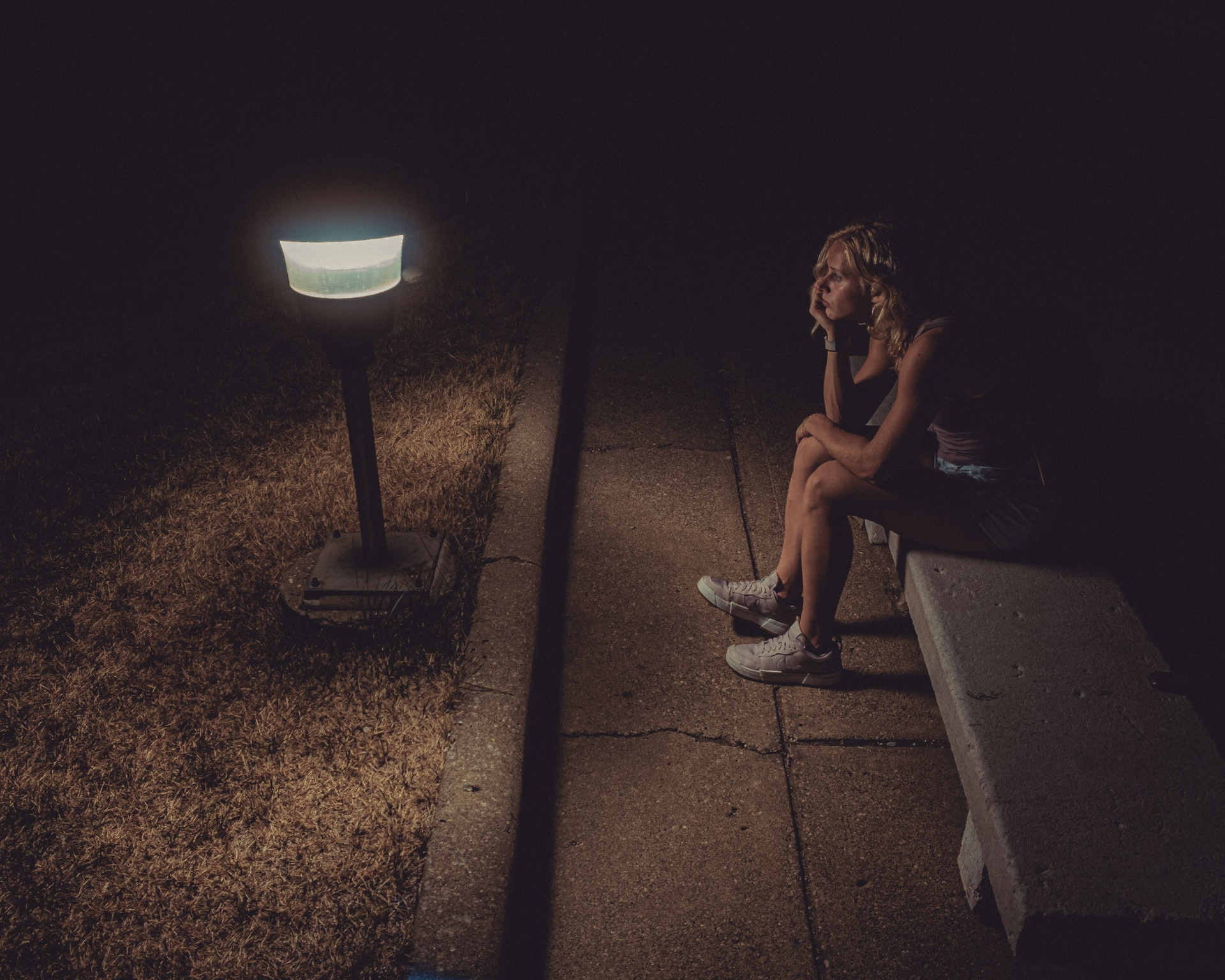 woman sitting in dark, loneliness, fear, 