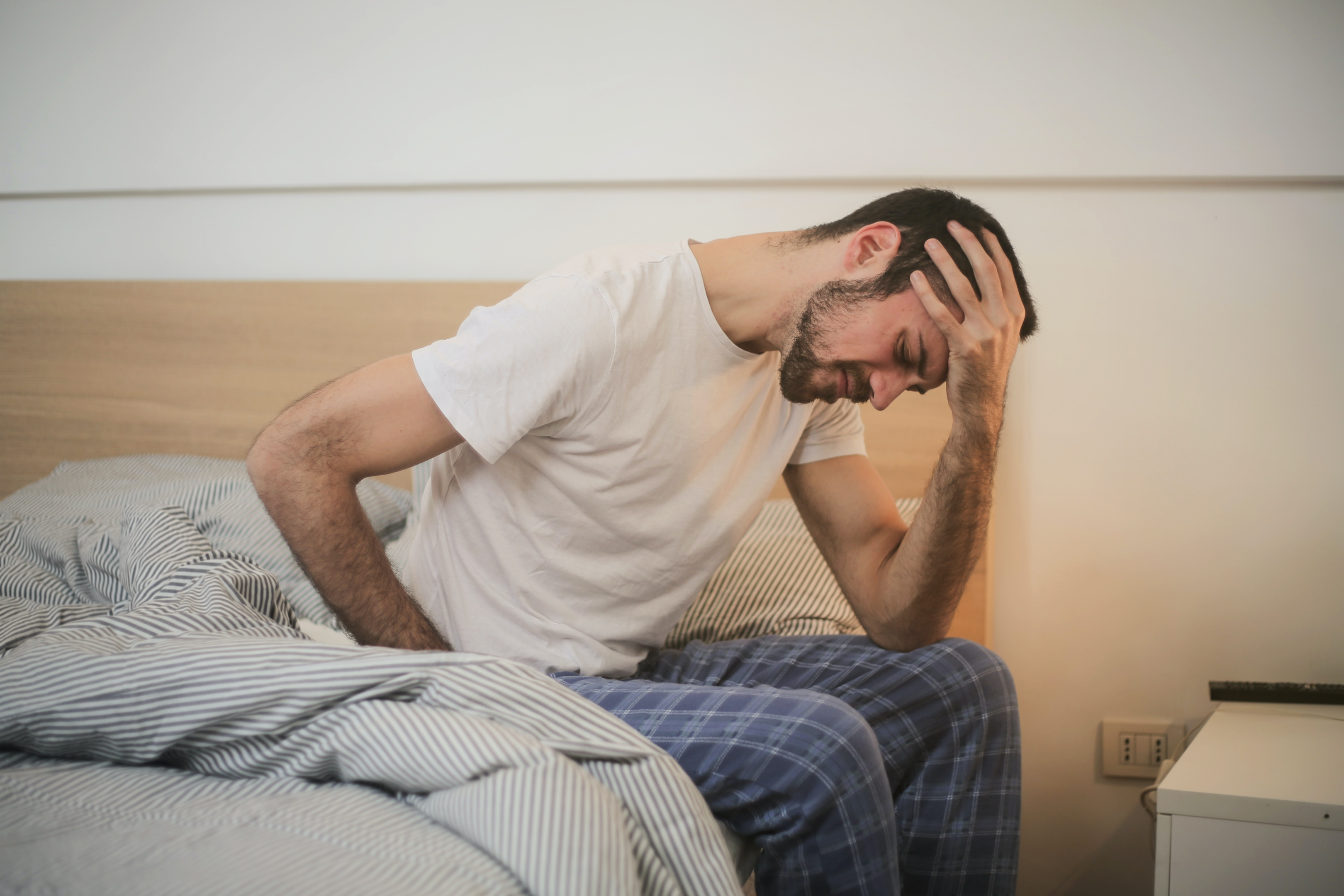 Photo by Andrea Piacquadio: https://www.pexels.com/photo/young-man-in-sleepwear-suffering-from-headache-in-morning-3771115/