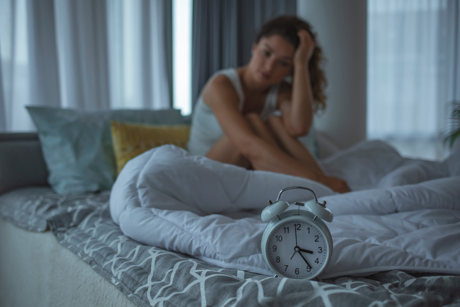 Woman experiencing sleep disruptions.