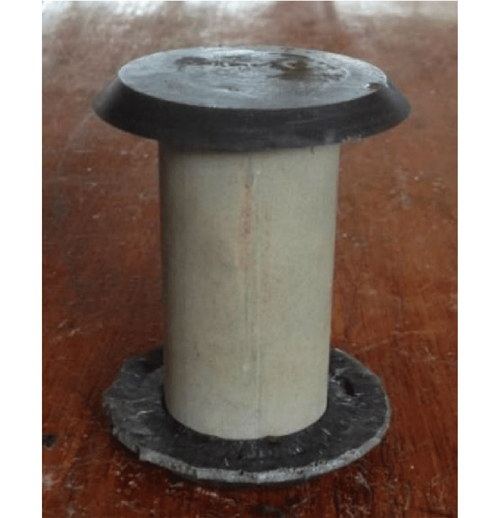 A concrete test cylinder with a sulfur based capping compound applied to the top