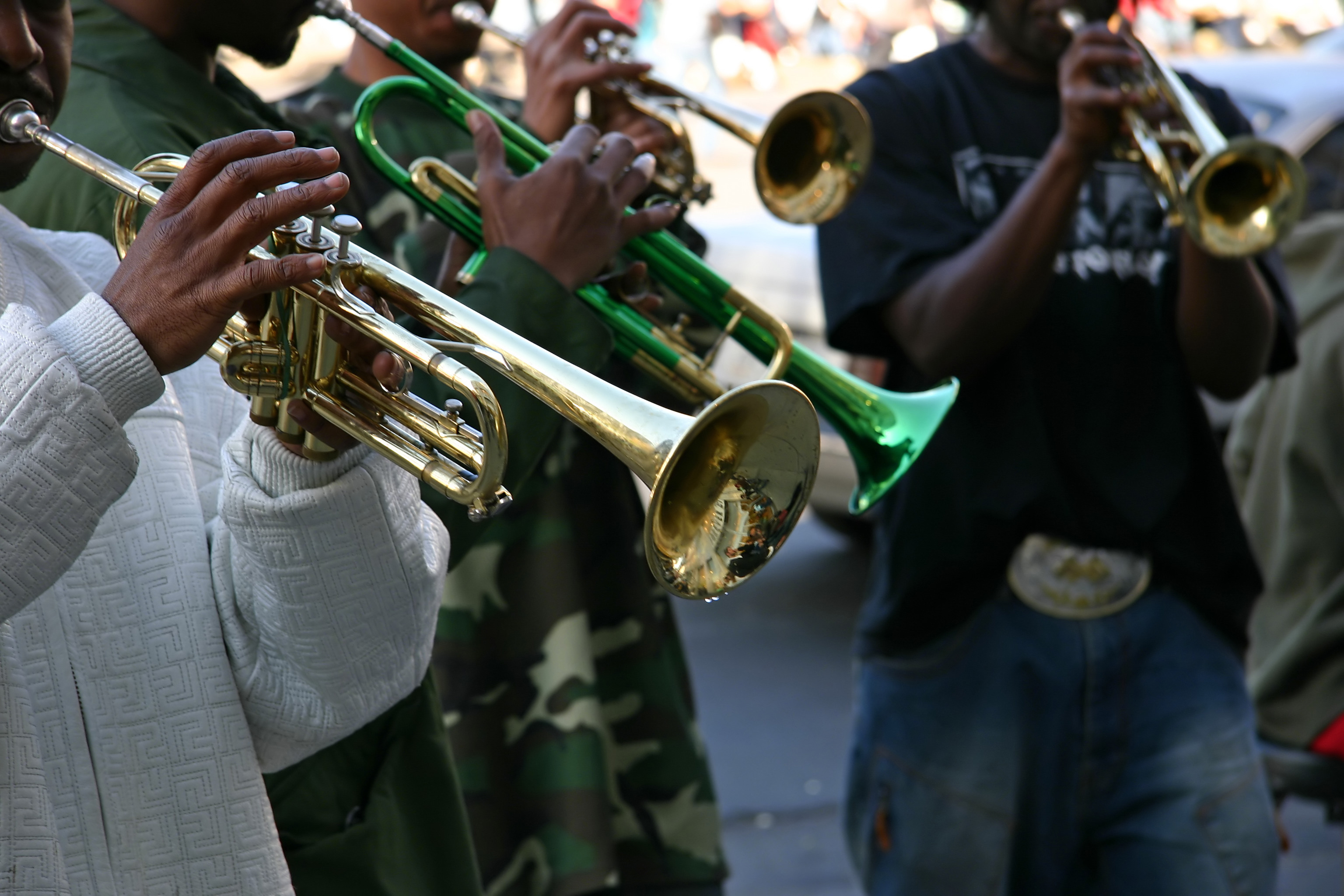 Trumpet players performing on a street corner 