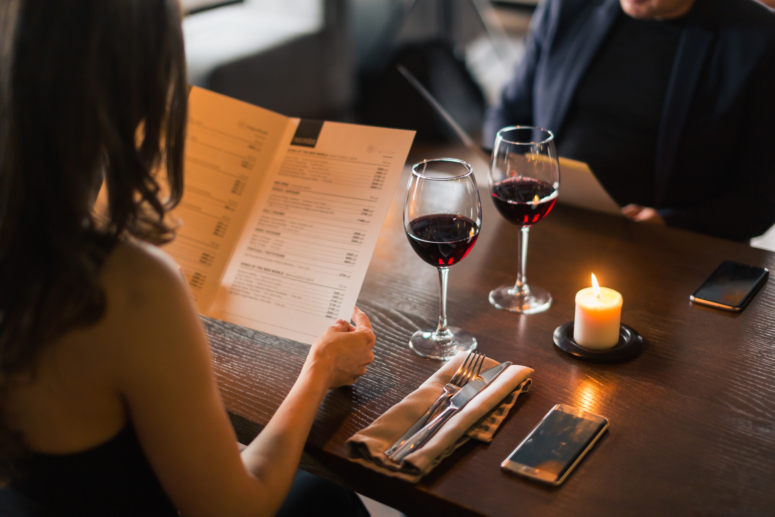 couple looking at a menu at an upscale restaurant