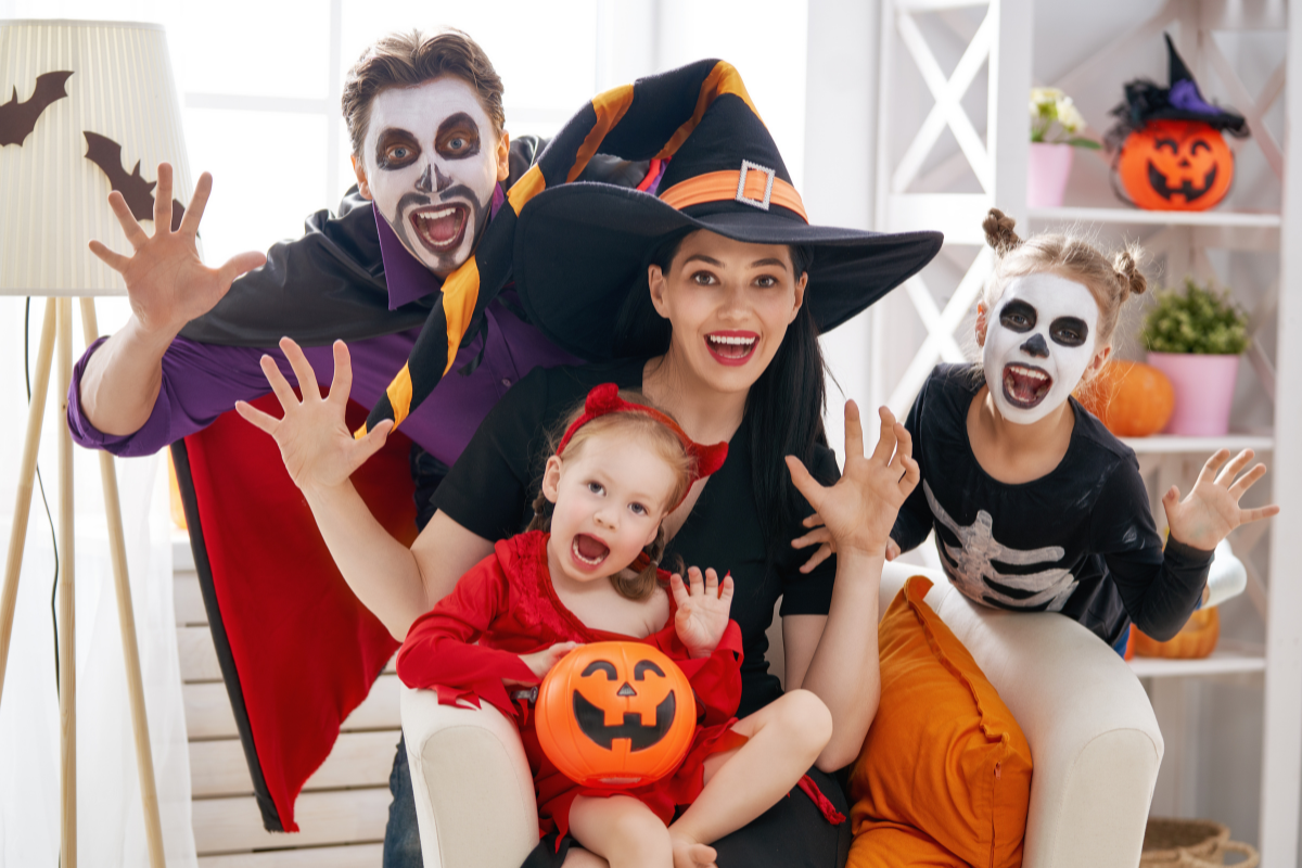 A family dressed in pop culture-themed Halloween costumes, including characters from popular movies.