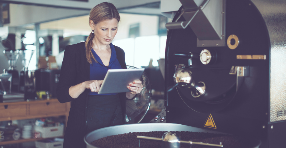 A woman beside a roasting machine