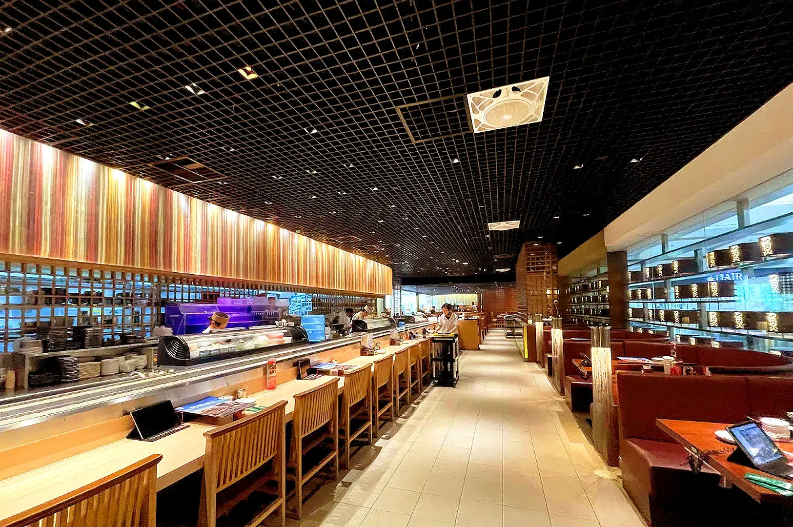 Sushi Tei Japanese restaurant interior near Orchard MRT with sushi counter, wooden seating, and warm lighting