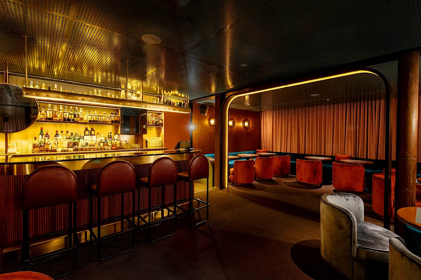 Jigger and Pony Singapore cocktail bar interior with stylish seating and warm lighting