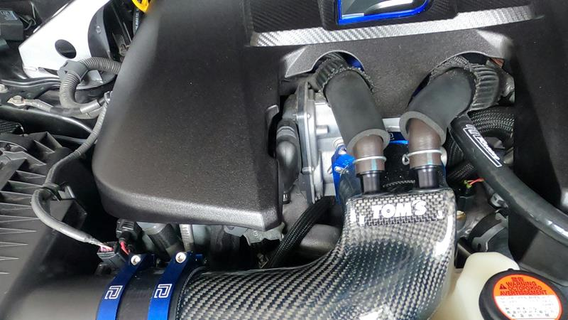 Close up of car engine showing rubber tubing