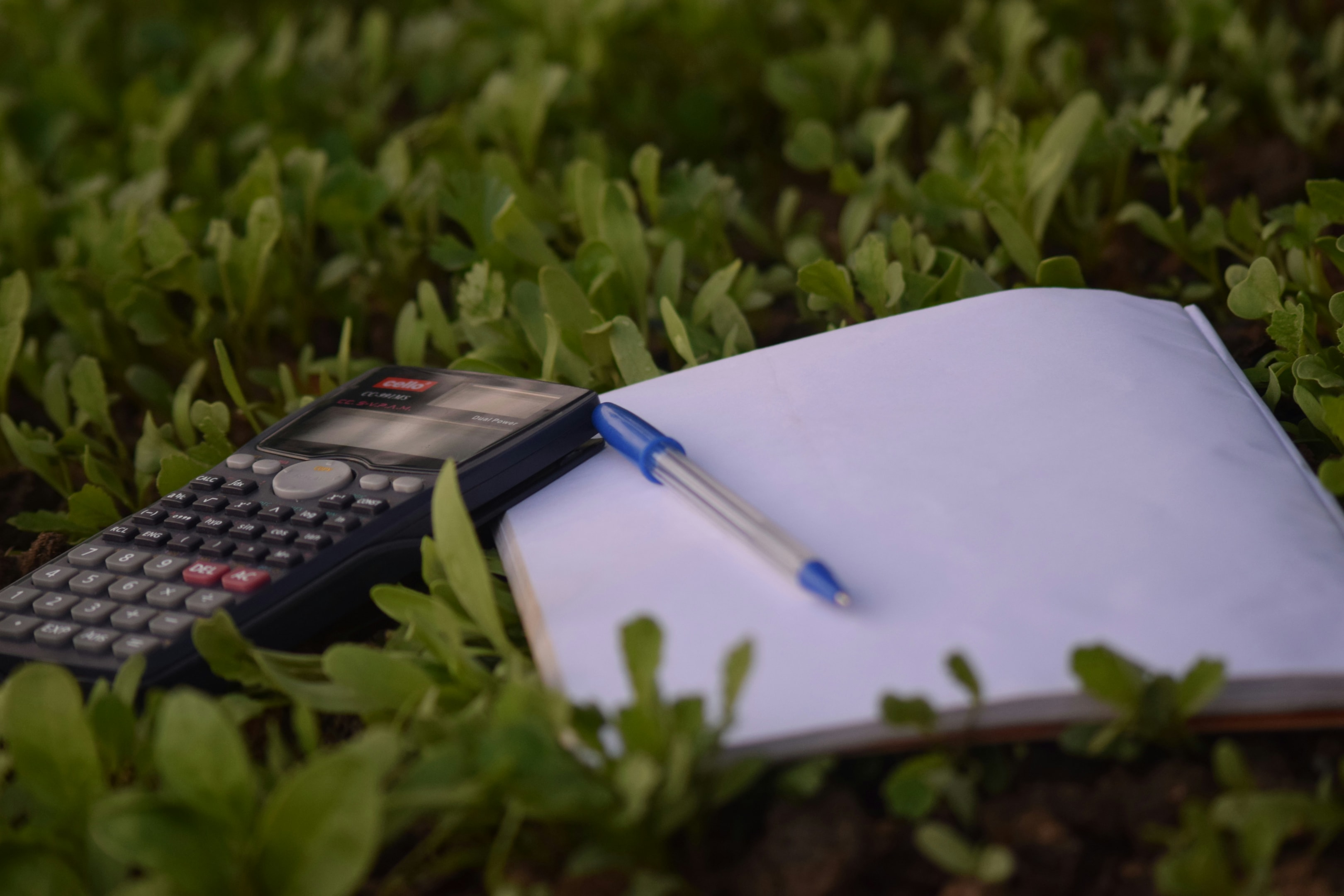 Real estate investor plans financing for new property with paper and calculator.