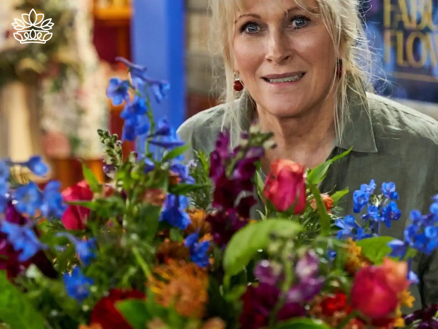 Florist arranging a stunning display of multicoloured flowers with a focused expression. Fabulous Flowers and Gifts, Luxury Flower Arrangements.