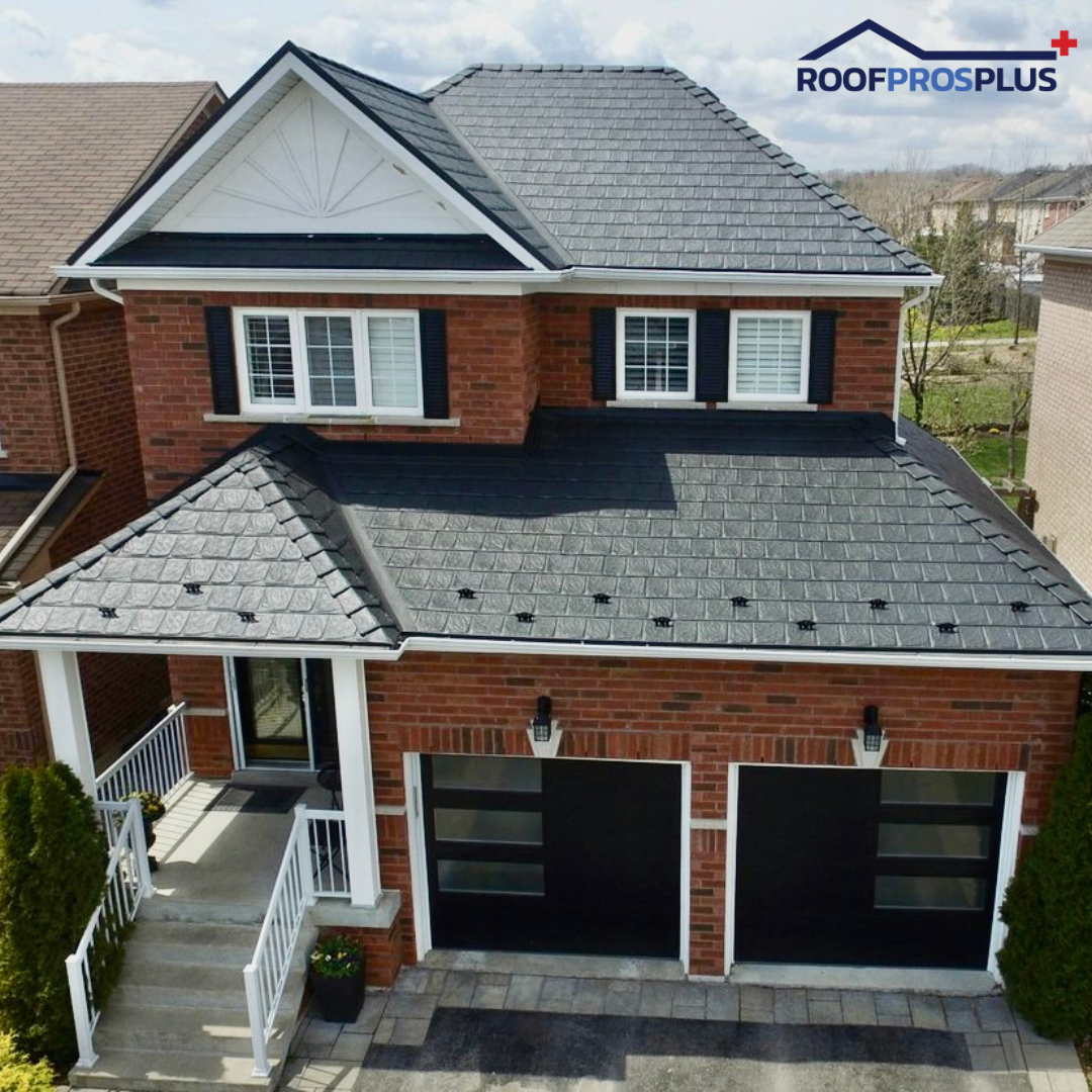 Modern two-story brick home featuring a sleek black Armadura metal roof installed by Roof Pros Plus, showcasing durable interlocking steel panels and a clean, upscale appearance