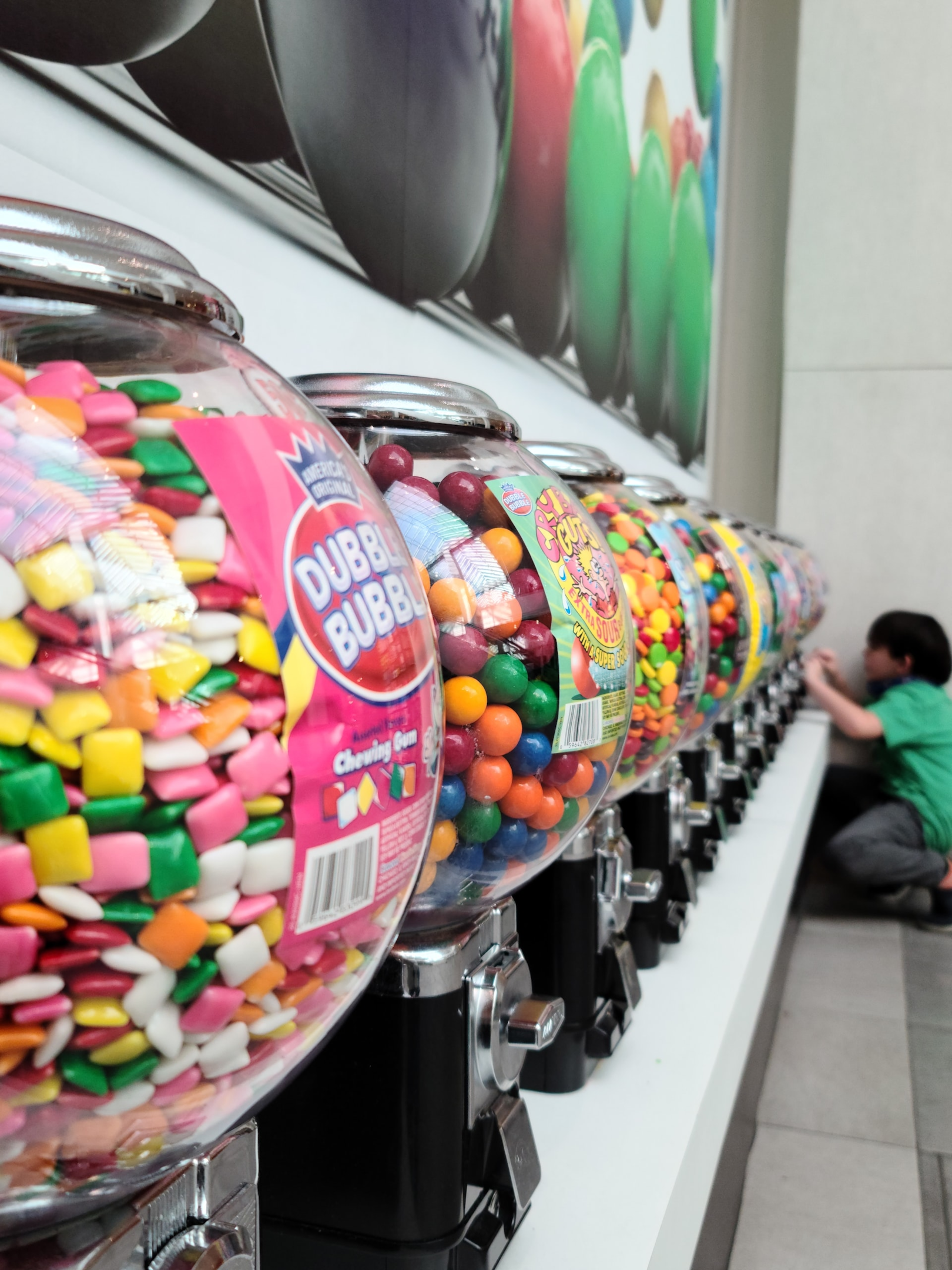 bulk vending machines in a row filled with colourful sweets