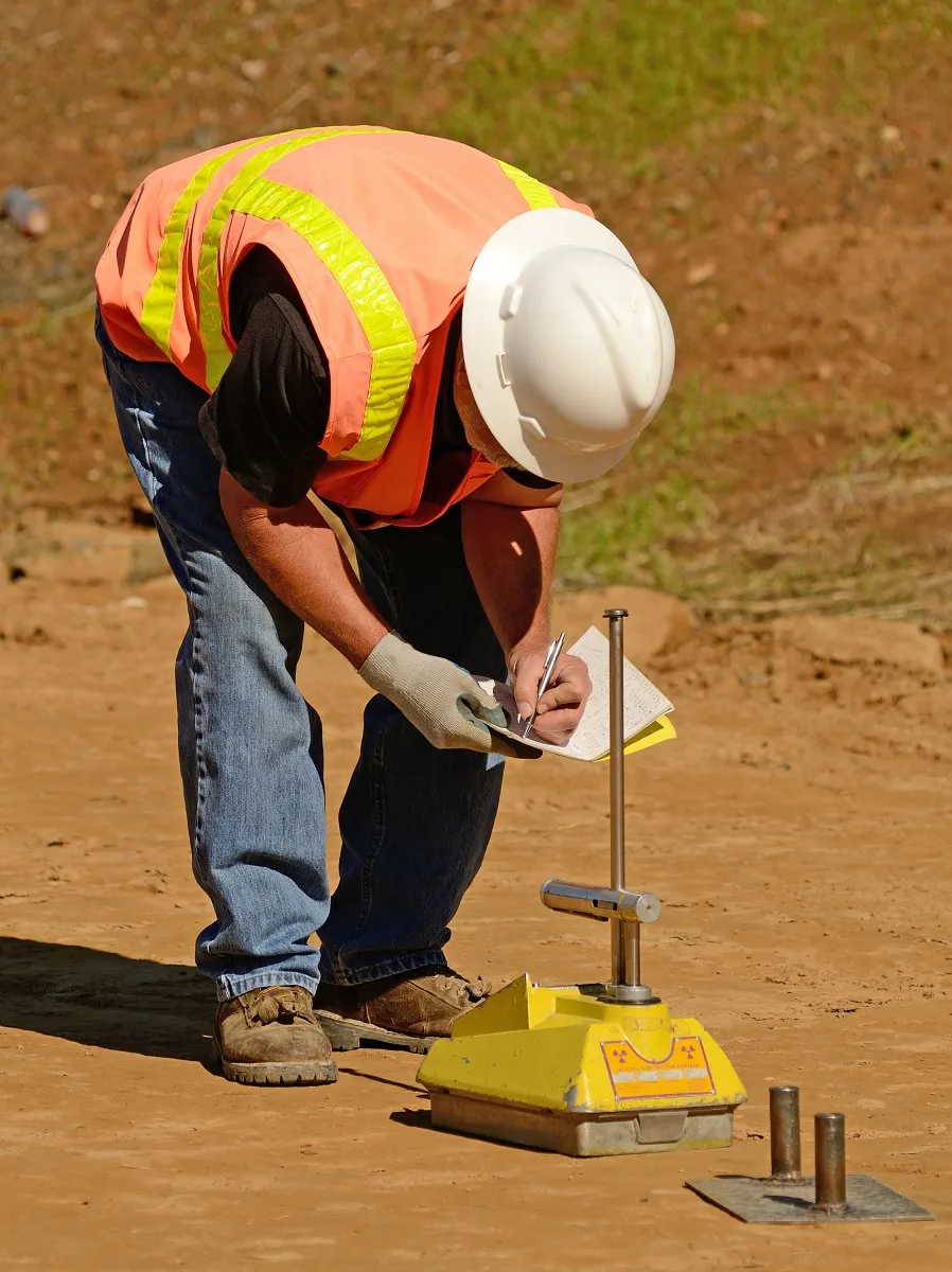 An image showing a soil density testing device being used to perform accurate density testing according to best practices.