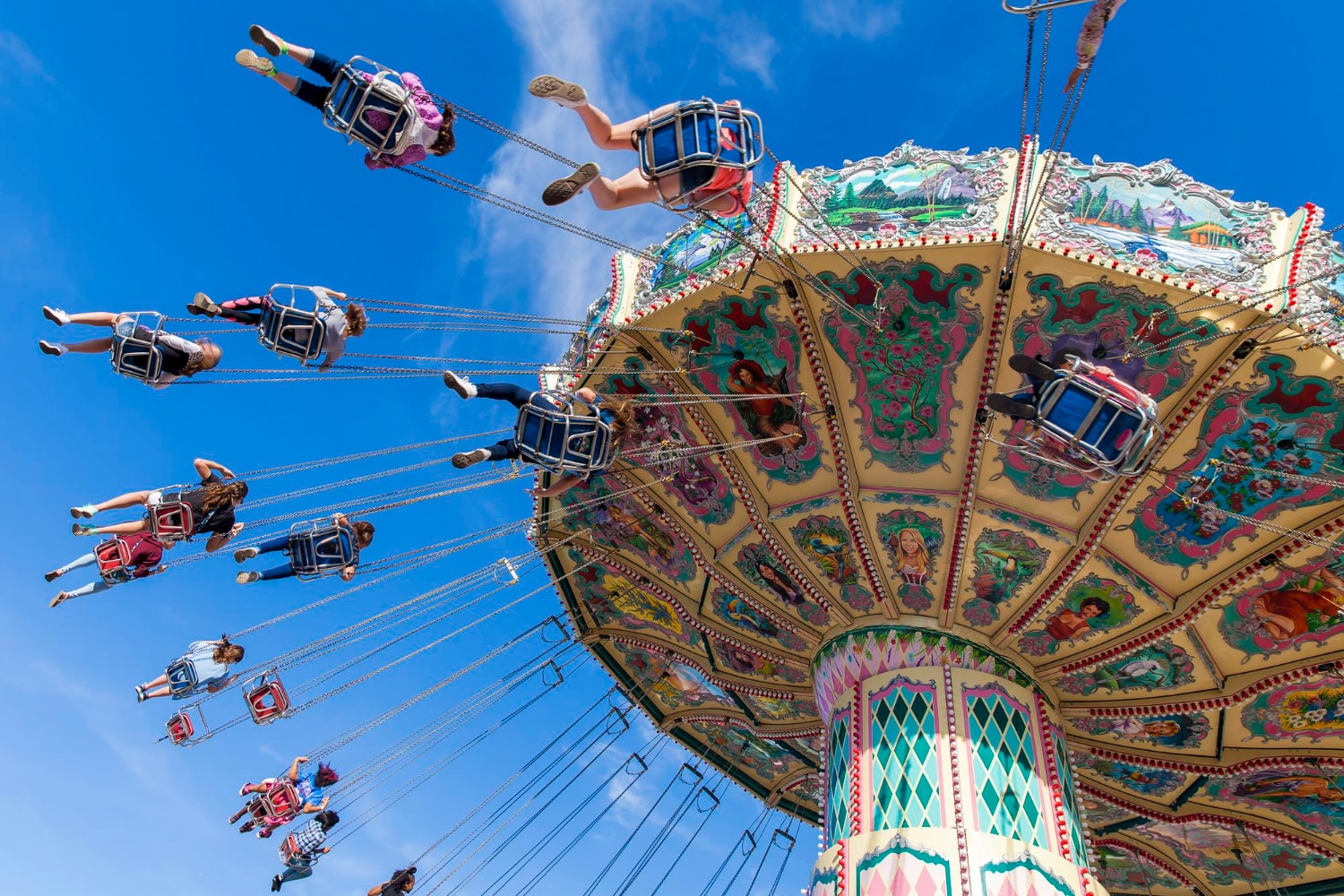 A thrilling amusement park ride with people swinging high against a bright blue sky. Just as rides provide excitement, businesses in Citrus Park and Tampa rely on business phone service and local VoIP providers to keep communication smooth and efficient.