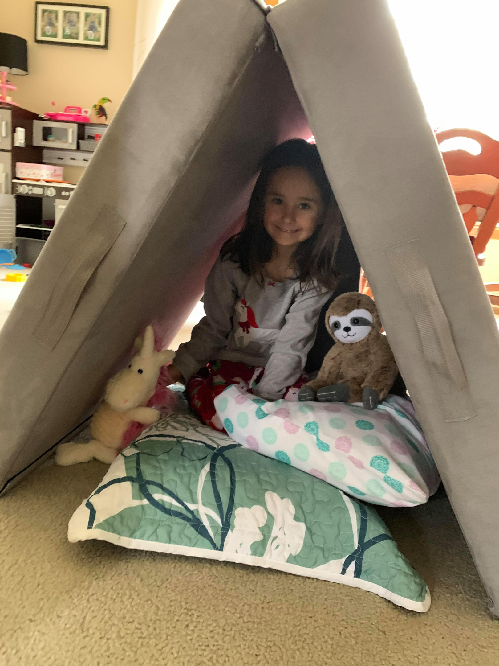 Girl with her stuffie in a Figgy indoor tent