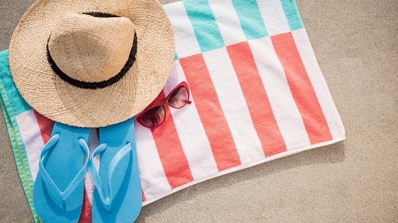 A folded beach towel with accessories
