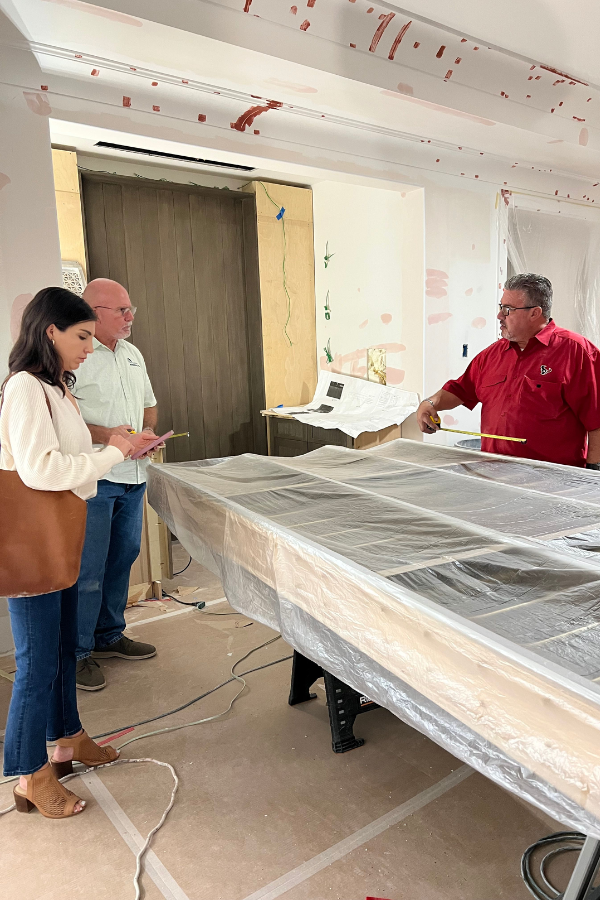 an interior designer meets with contractors on-site