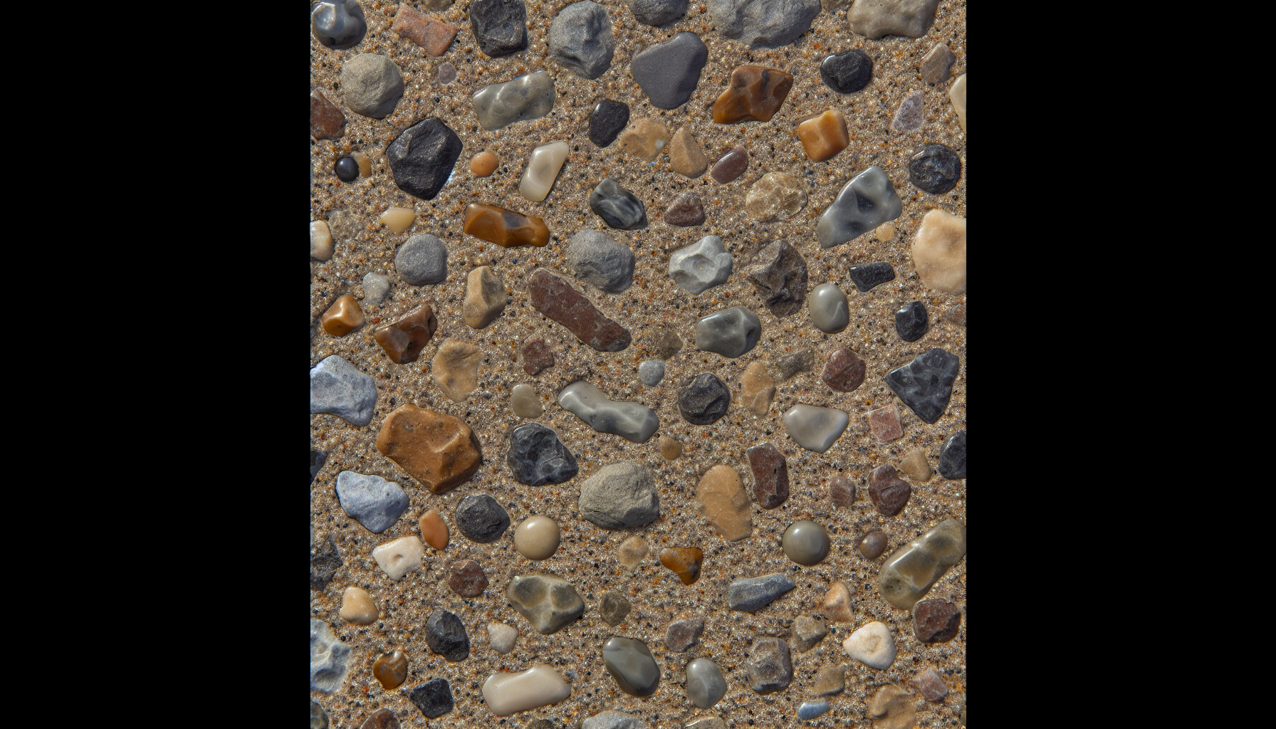 Exposed aggregate concrete surface with decorative stones