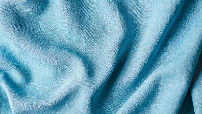 A close up shot of a blue lyocell fabric