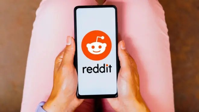 A woman using Reddit app