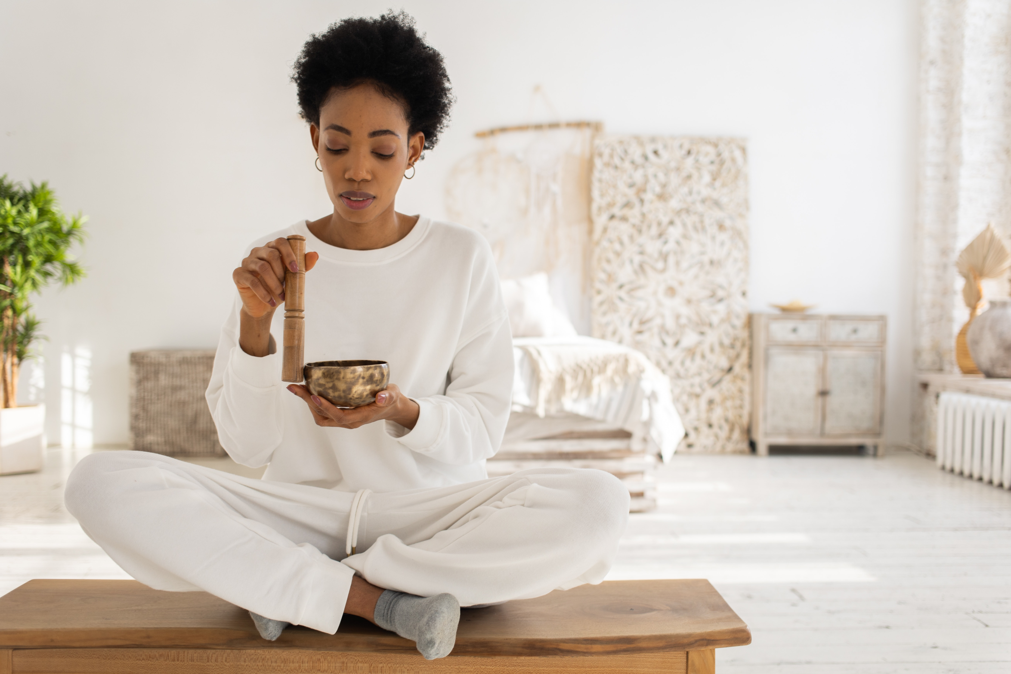 woman preparing for meditation with singing bowl