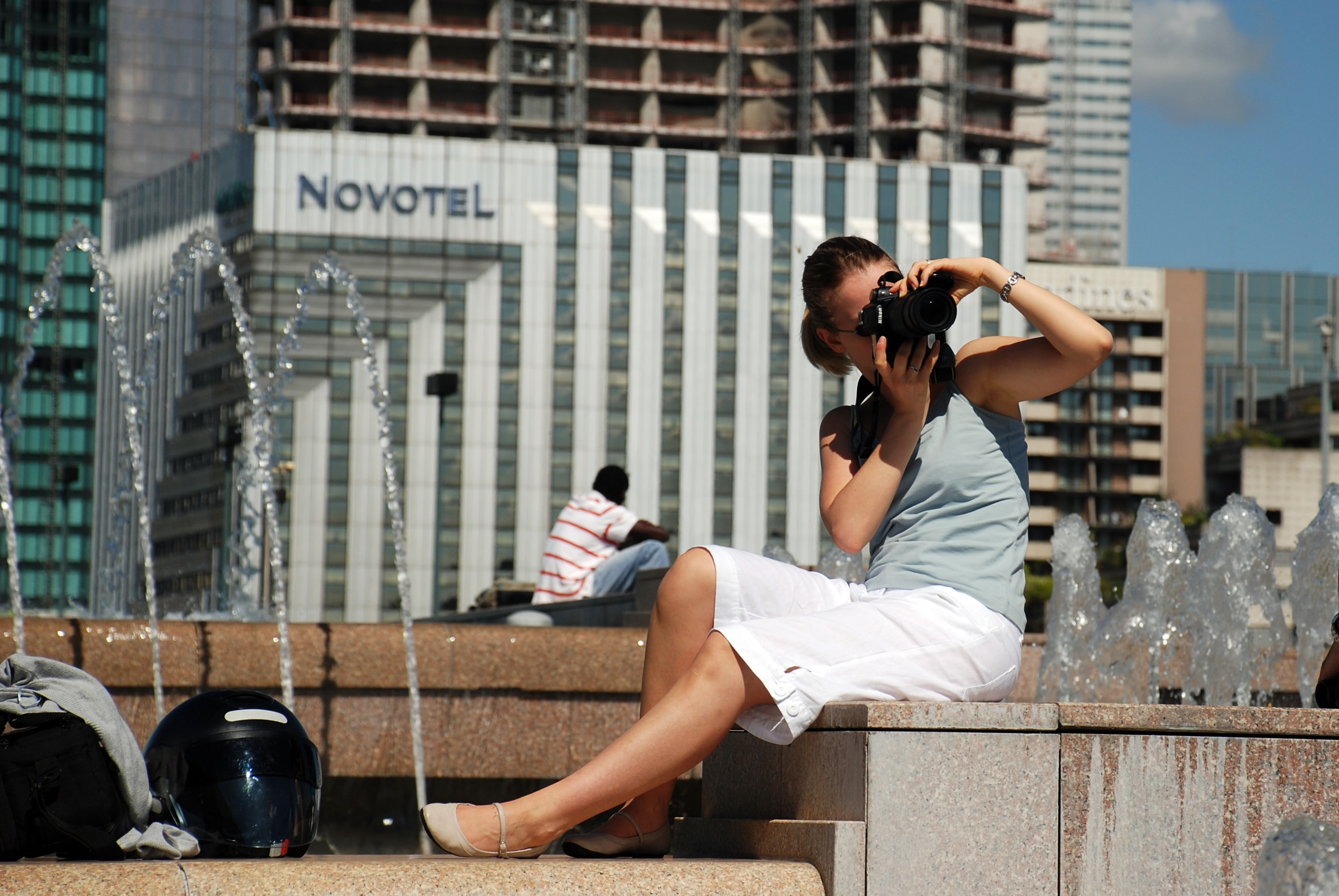 Woman taking a photo in front of Novotel Hotel
