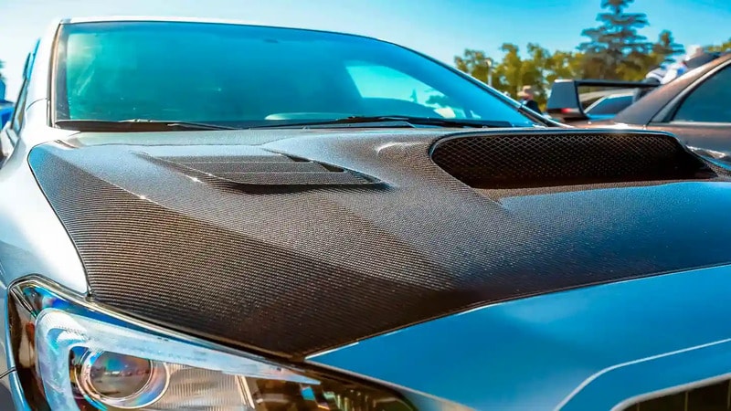 Vehicle hood wrapped with carbon fiber