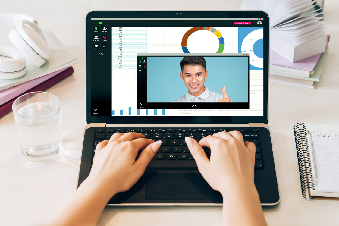 Male virtual assistant giving a thumbs up during a video call while presenting charts
