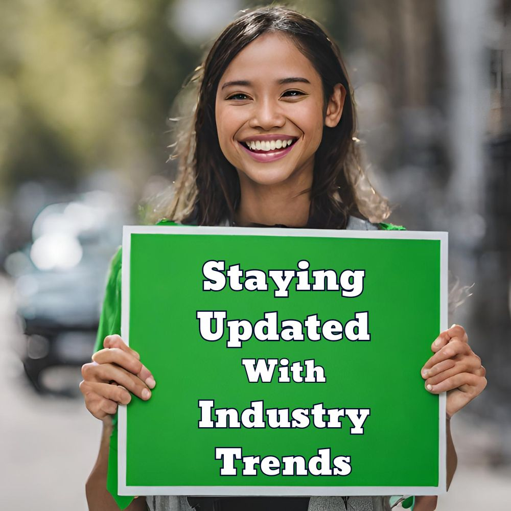 A person smiling while holding a sign with the words "Staying Updated with Industry Trends"