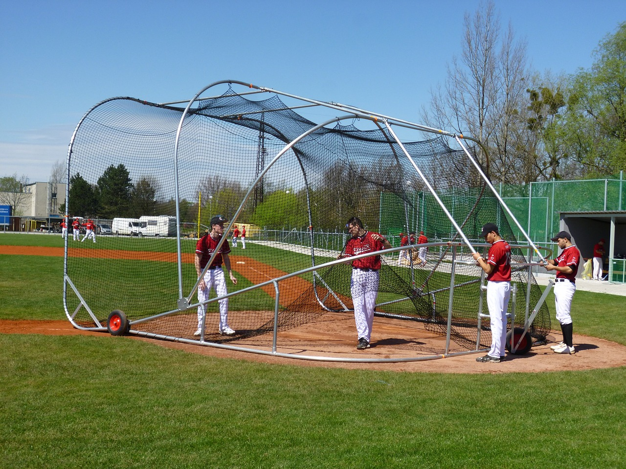 A semi-enclosed batting cage in a backyard