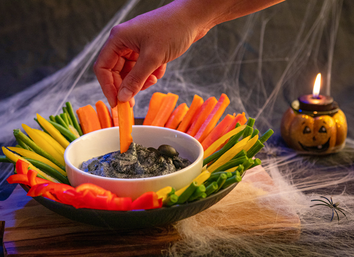 A bowl filled with fiber-rich vegetables such green beans, carrots, peppers, and bowl of black beans