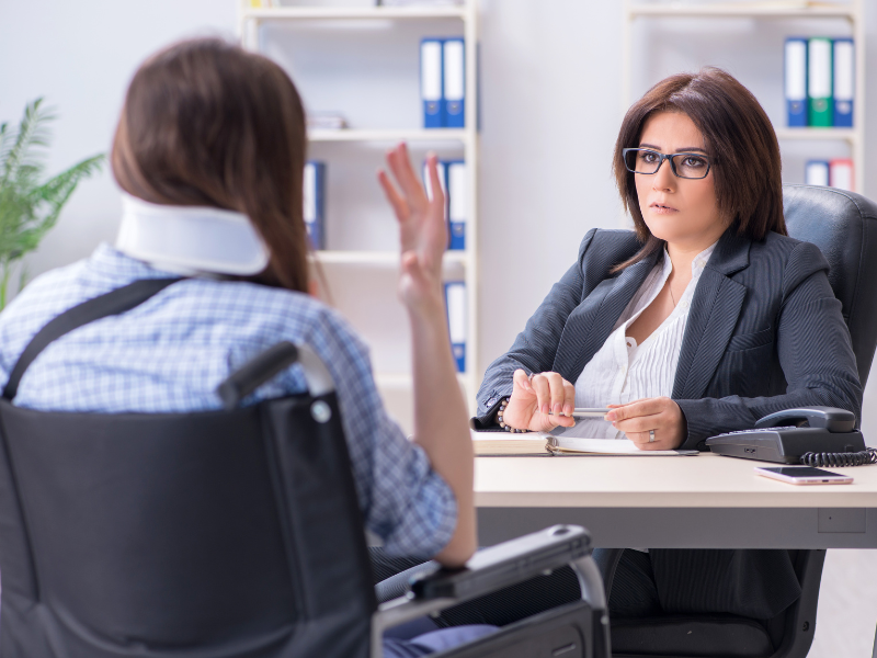 Image of a person consulting with a lawyer about a personal injury case.