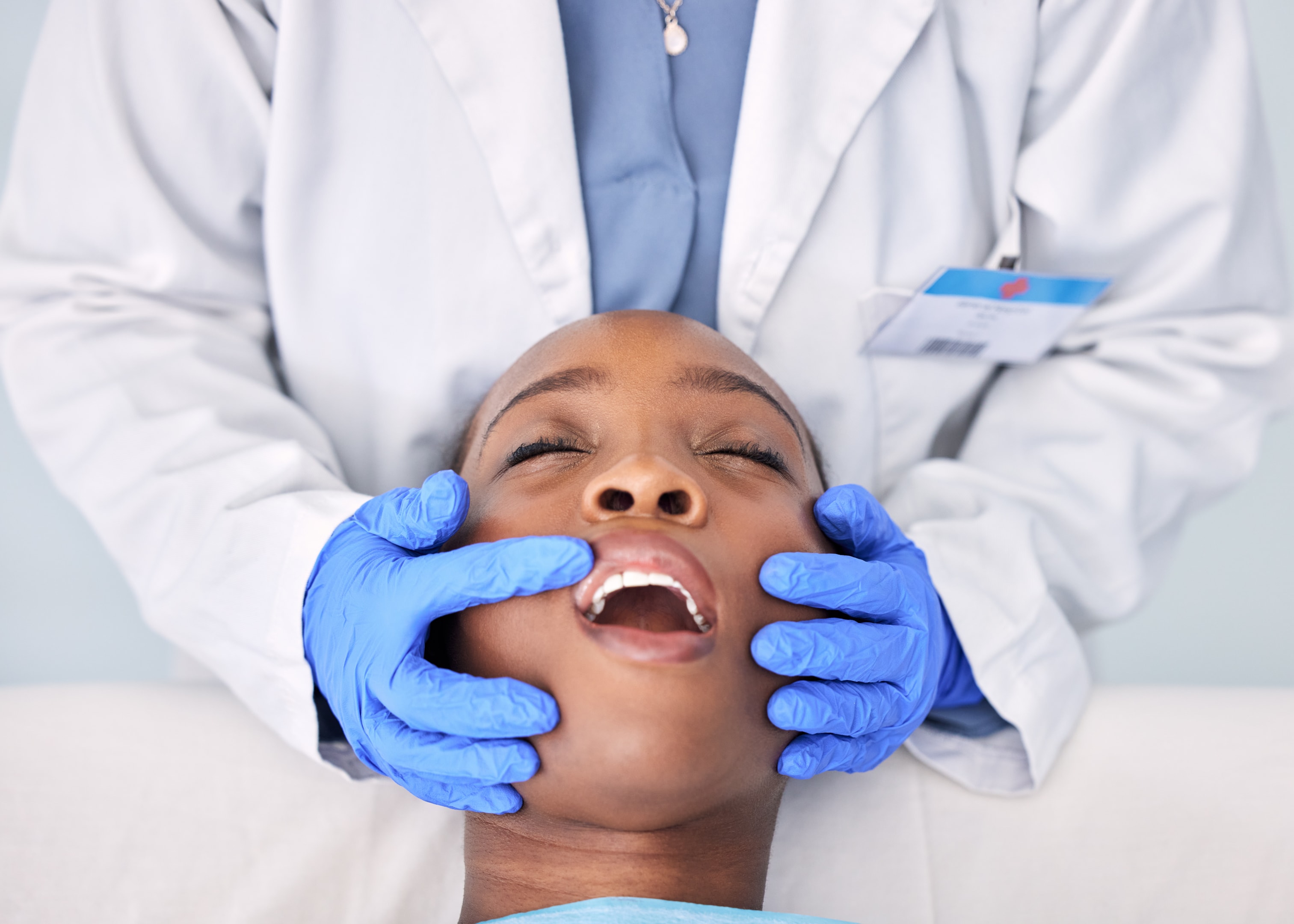 WOman getting examined for wisdom tooth extraction