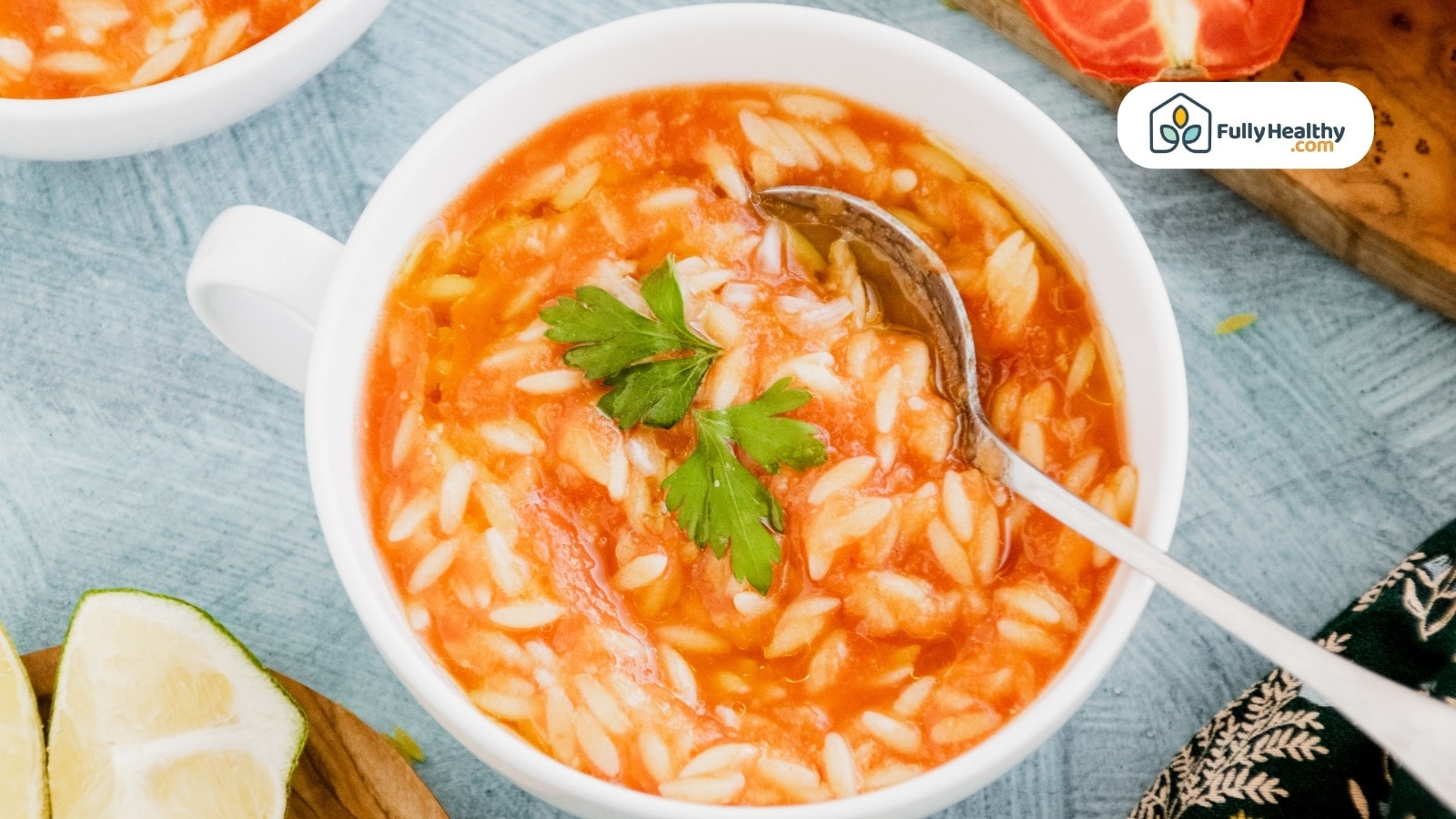 Tomato-based soup with orzo and fresh parsley garnish