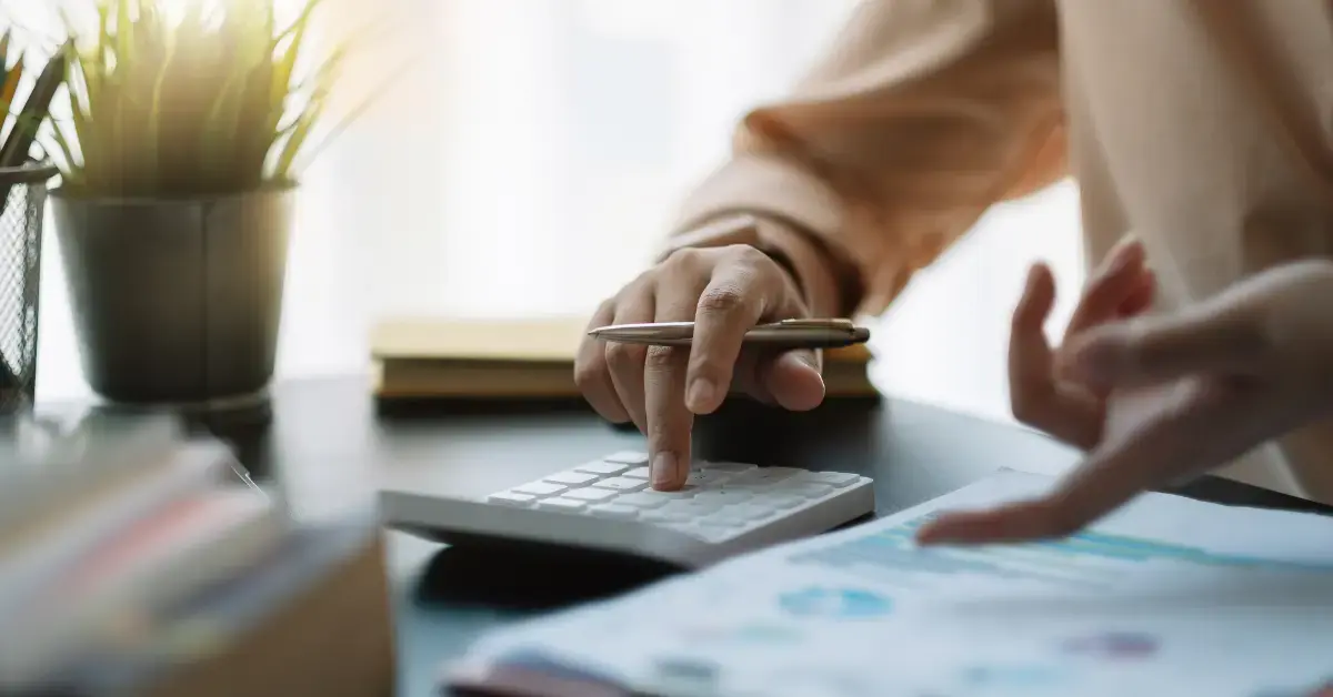 Woman reviewing income and receipts while learning how to separate business and personal expenses.