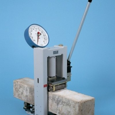 A concrete tester being used to test the strength and durability of cementitious materials.