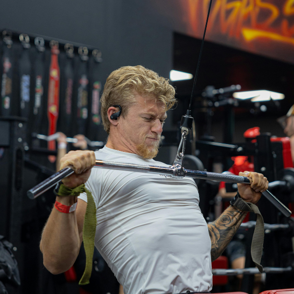 An image showing a person doing an overhand grip on a lat pulldown bar.