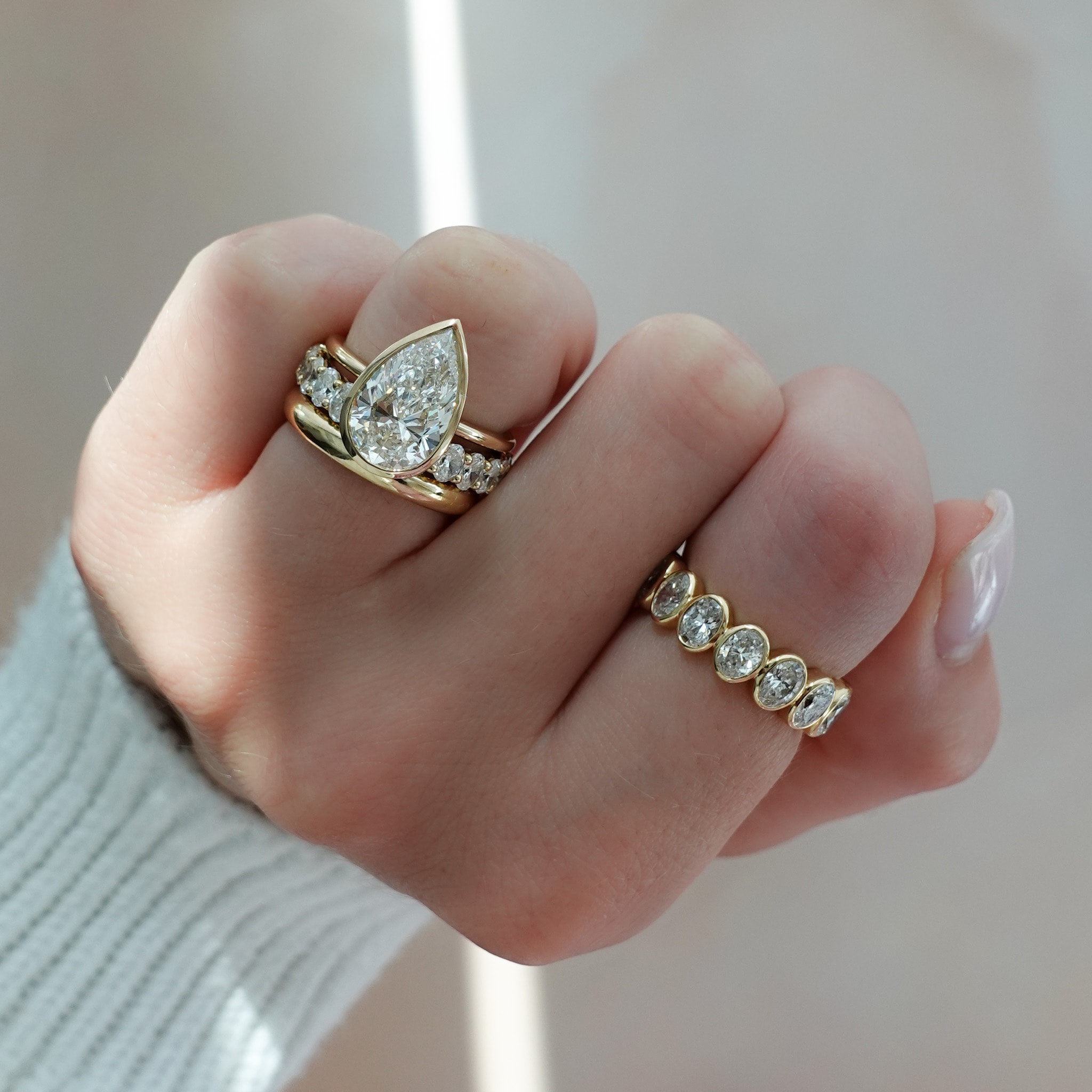Bezel set engagement ring with a pear cut diamond