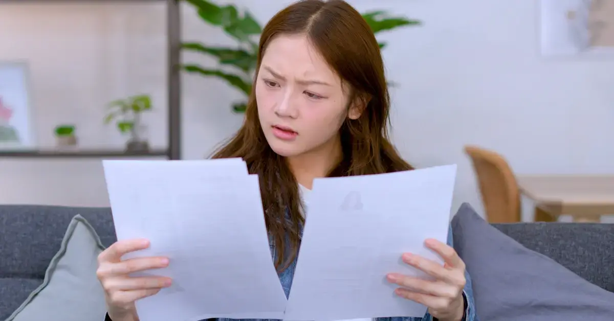 Female creator reviewing a notice of intent to levy and unpaid tax documents before IRS collection action.
