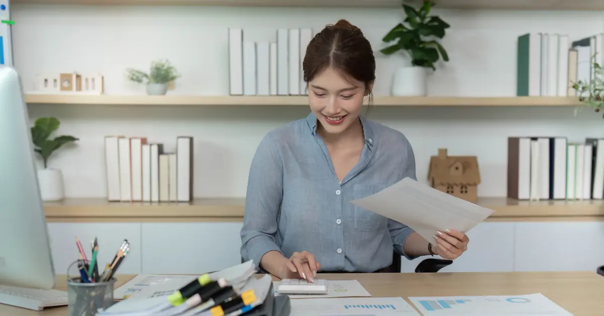 Woman reviewing tax checklist and C Corp tax filing documents to avoid common filing mistakes.