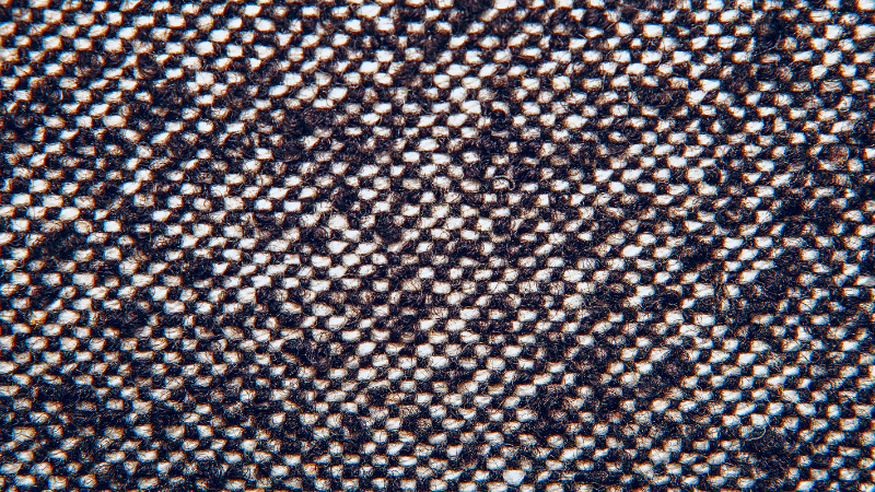 A close-up image of a white and black twill fabric