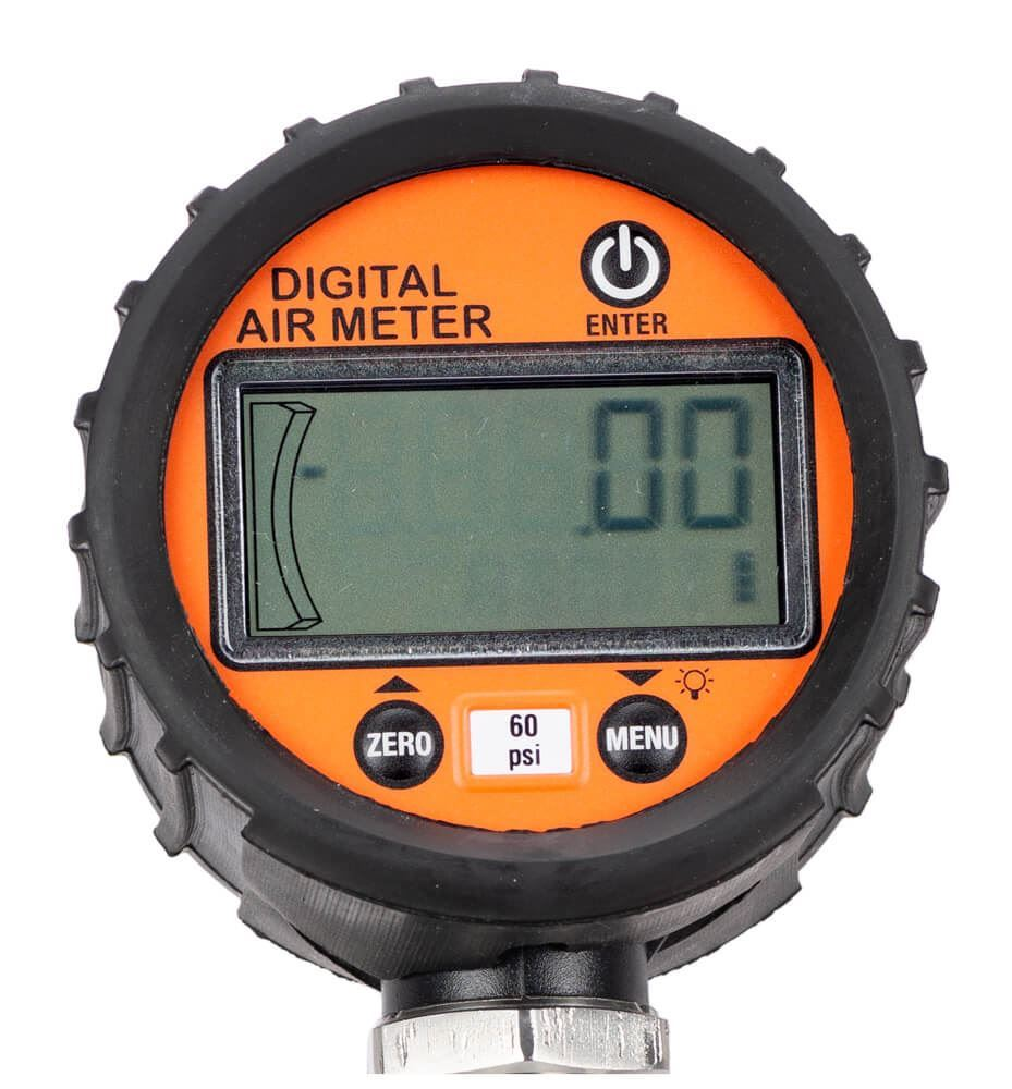 A scientist comparing digital and analog gauges of a concrete air meter