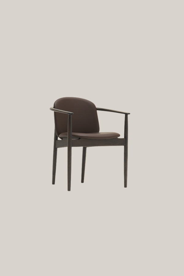 Contemporary Japanese dining chair with a curved upholstered seat and backrest, slim wooden frame, and gently angled armrests.