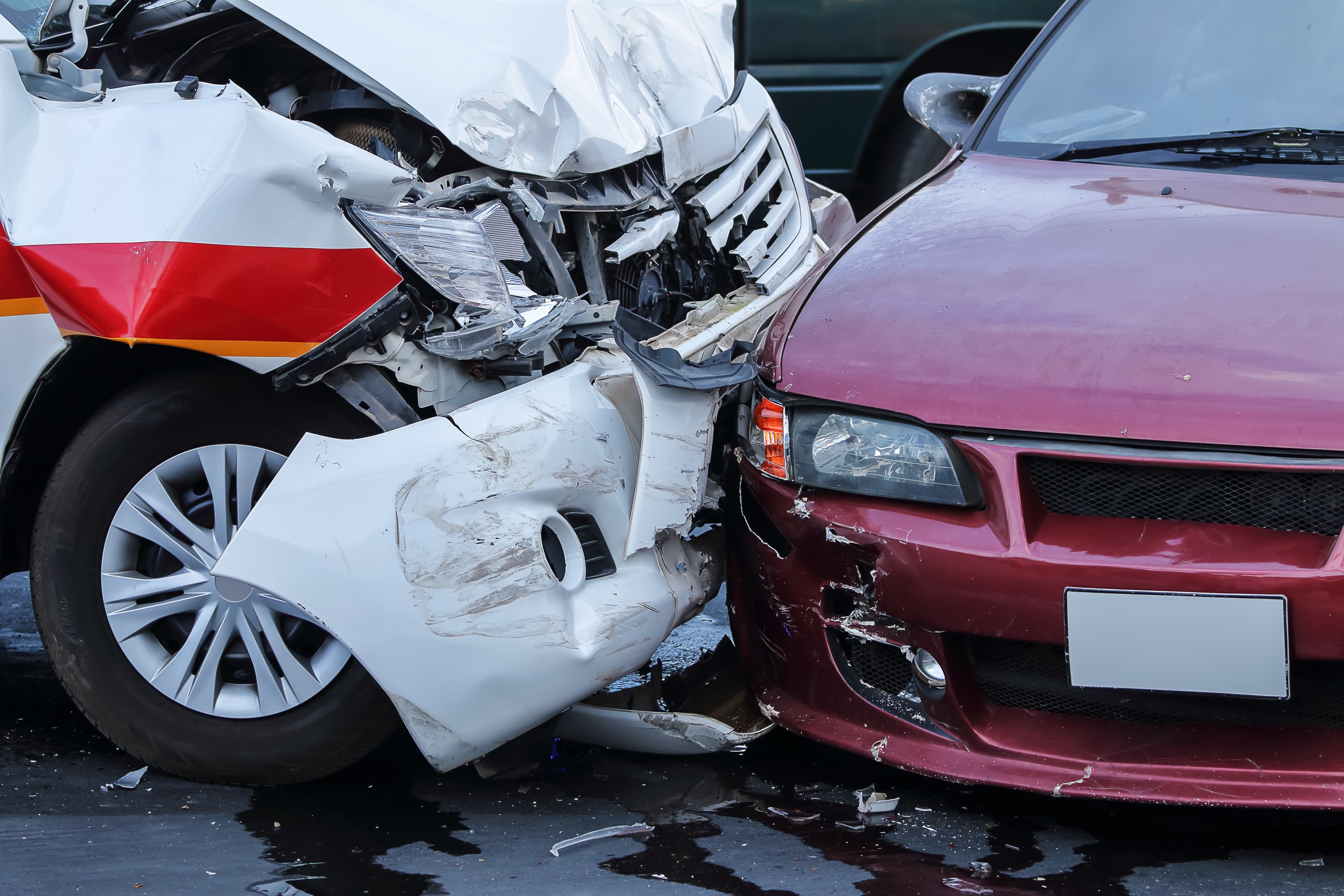 A white car crashes into a red car in an example of a passenger accident