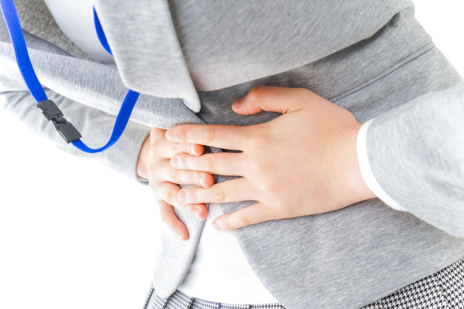 Person holding stomach in discomfort.