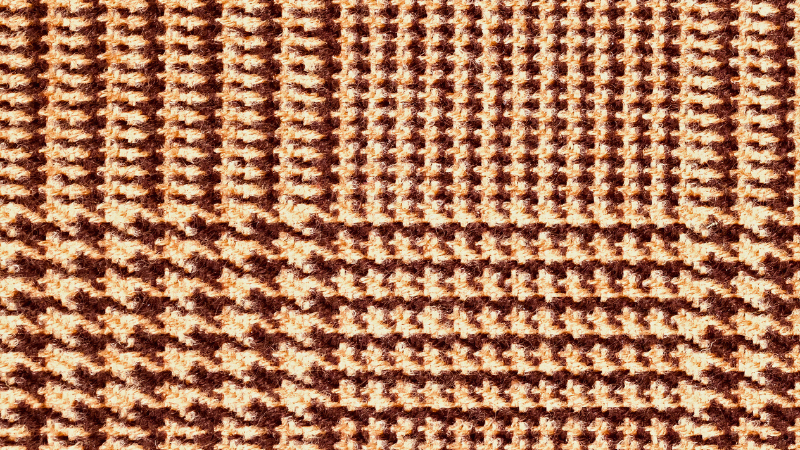 A close-up image of a brown and white dogtooth fabric