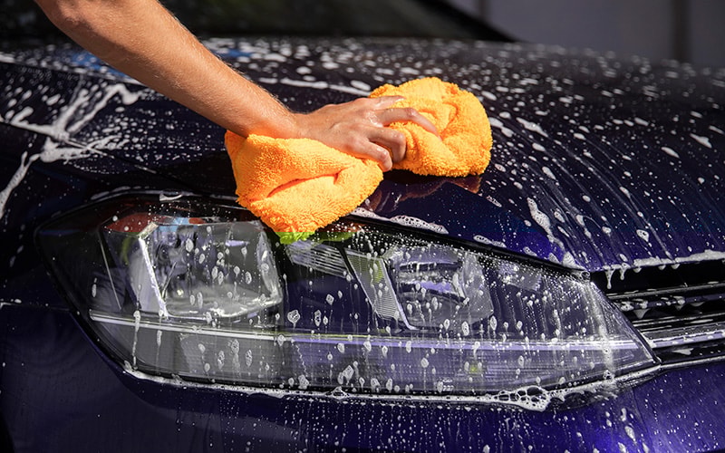 Cleaning the car with a towel